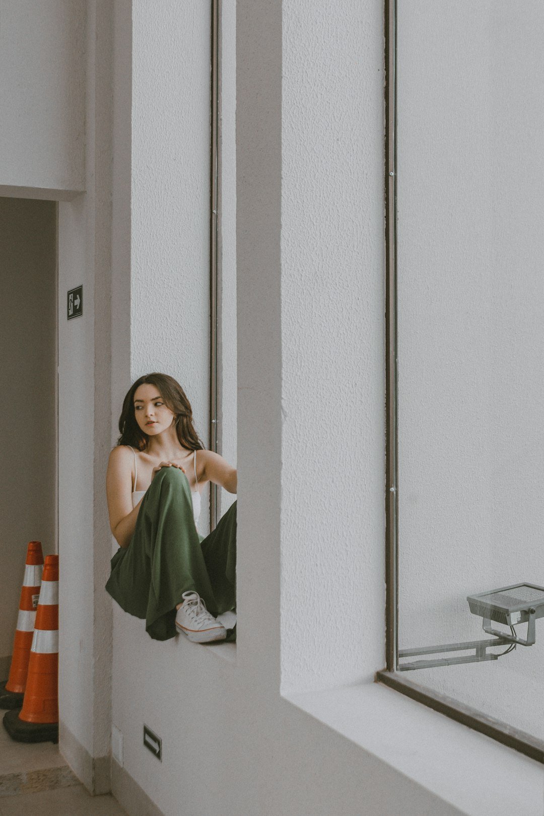Woman sitting by a window in a quiet reflective moment